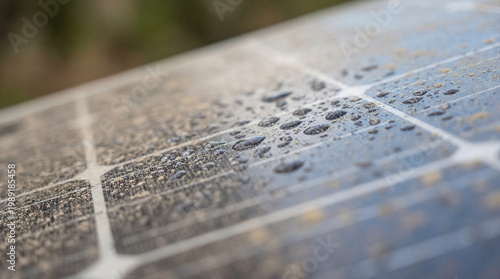 Closeup of a dirty solar panel with water droplets after rain