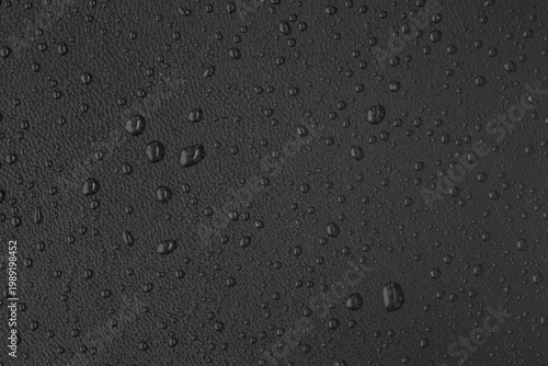 Фотография Macro leather texture with water drops, waterproof and hydrophobic surface conce