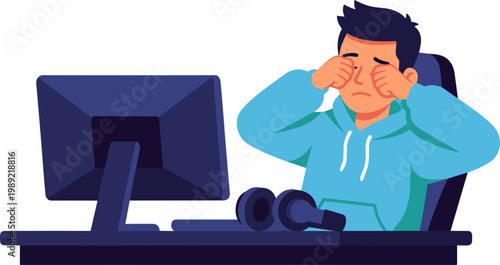 Man sitting stressed at desk with computer and headphones on