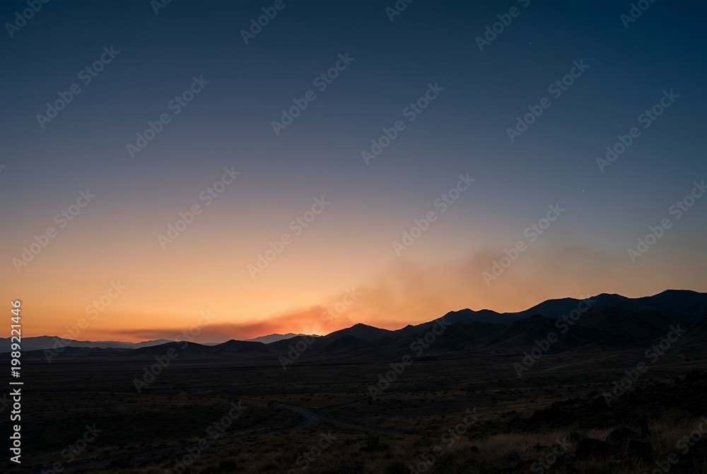 Fototapeta premium Desert landscape at dawn with mountains and orange horizon