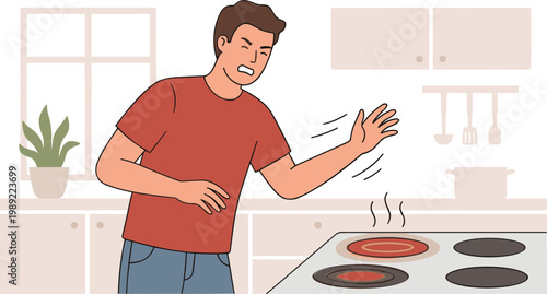 Man burns himself on hot stove in modern kitchen while cooking