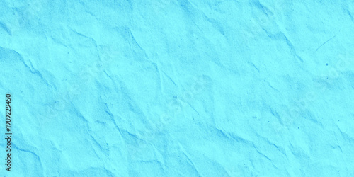 Light blue crumpled paper texture background with creases and wrinkles