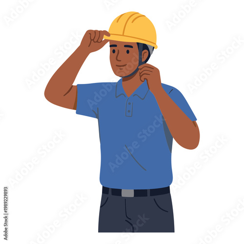 A man wearing a yellow hard hat adjusting it on his head indoors.