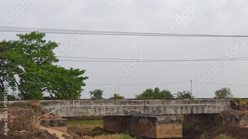 train in the countryside. Locomotive Express Train traveling on a railway pass through g paddy fields in the countryside at prachinburi, Thailand.