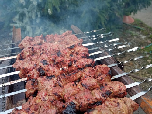 Shish kebab on skewers is cooked in the fresh air.