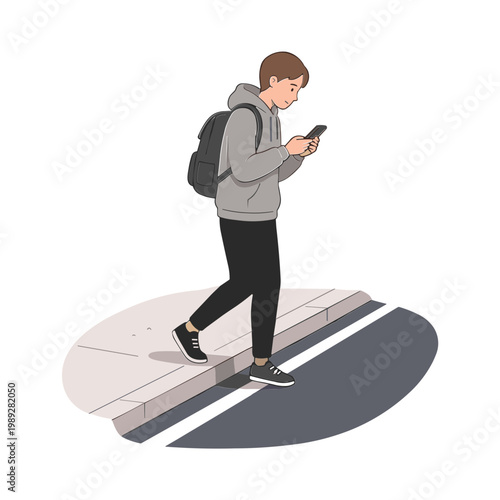 A young man walks on a sidewalk while looking at his phone.
