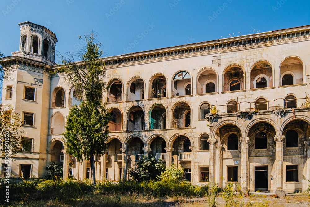 Fototapeta premium Abandoned Sanatorium Iveria in Tskaltubo, Georgia — Soviet-era architecture reclaimed by nature and time