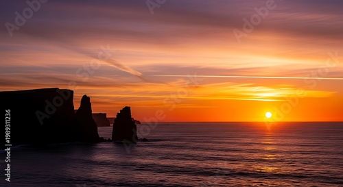 Sunset, ocean, rocky shoreline, vibrant colors, serene landscape