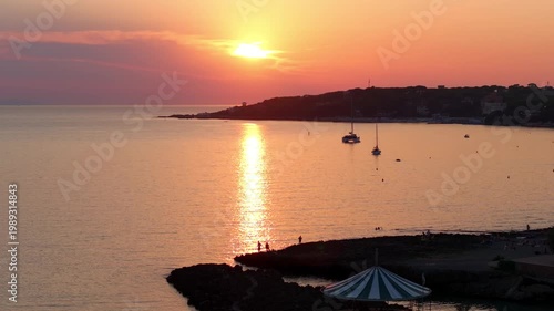 end of day Tuscan sunset, semi-panorama on the sea in Castiglioncello, Italy, coastal luxury enclave, shoreline onlooker silhouettes
