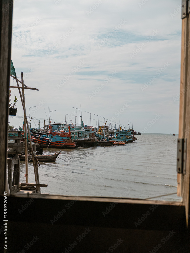 Fototapeta premium Serene scene of fishing vessels in calm maritime setting