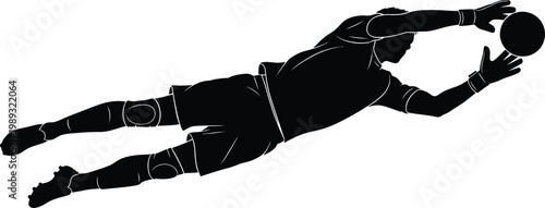 Silhouette of a goalkeeper diving mid air to catch a soccer ball during an intense match