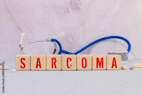 Medicine concept. On a blue background, wooden cubes and Jenga with the inscription - SARCOMA.