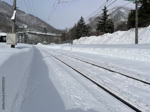 Snow covered train tracks at a station in Northern Japan