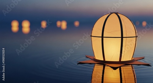 Glowing paper lantern floating on water