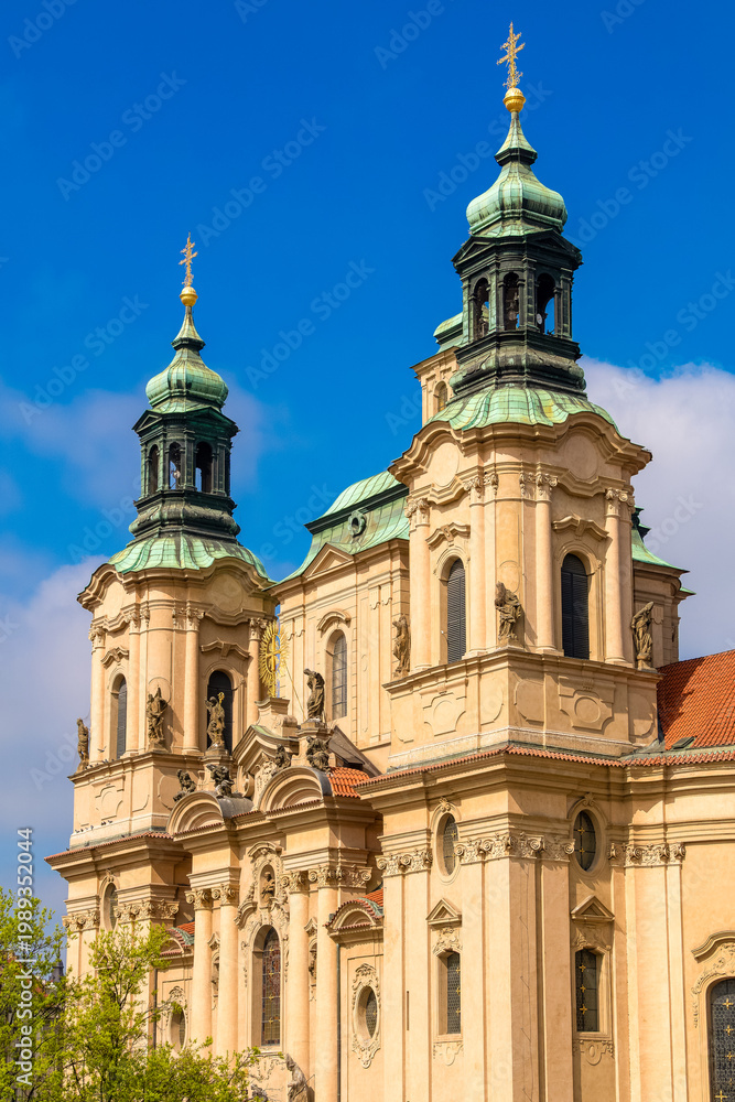 Fototapeta premium St Nicholas Church Prague in spring with blue sky