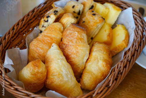 Basket of assorted freshly baked croissants.