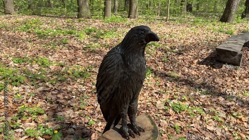 Wooden bird sculpture in forest setting, outdoor art and nature concept, carved figure, rustic design, natural environment, decorative object scene