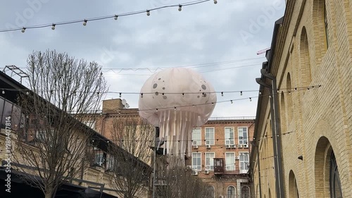 Urban courtyard with historic buildings and large dome structure, city architecture concept, old town atmosphere, outdoor scene, travel and culture