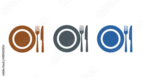 Set of three colorful ceramic plates with matching cutlery arranged on a flat surface for dining or table setting