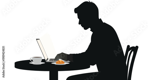 Silhouette of a man working on a laptop with breakfast nearby