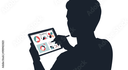 Silhouette of a person designing graphics on a digital tablet
