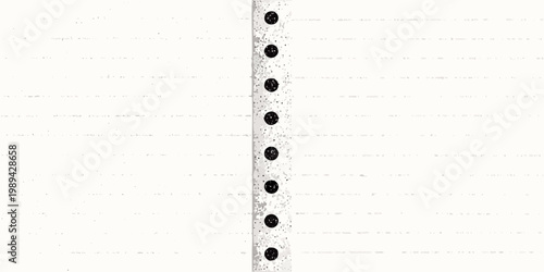Close up of a white lined paper with black hole punches down the side