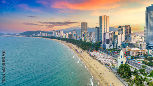 Fényképezés Beachfront scene in Nha Trang, Vietnam at sunset, where crowds of locals and tourists relax along the sandy shore