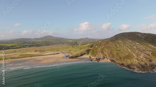 Aerial view of a picturesque river estuary flowing into the Atlantic Ocean from sandy beaches.