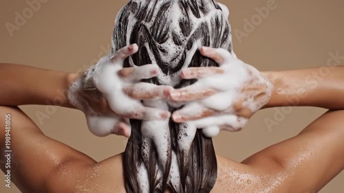 Woman washing her long hair with shampoo in the shower