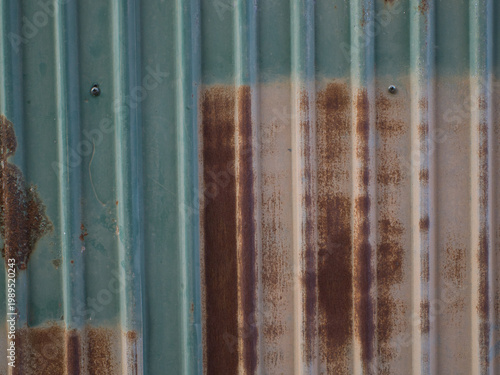 Photos Galvanized fence wall is rusty.