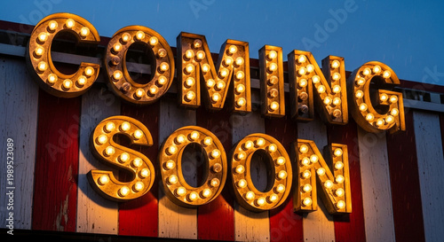 Vintage marquee sign with Coming Soon text, retro theater light bulbs on striped background, glowing cinematic announcement board