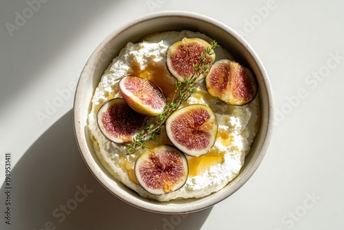 A ceramic bowl of ricotta with fresh figs and a drizzle of honey, top-down view, bright natural light, creamy texture, sweet and savory
