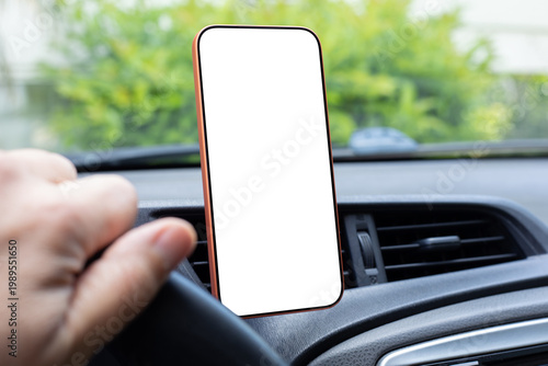 Smartphone with isolated white screen mockup on car dashboard interior