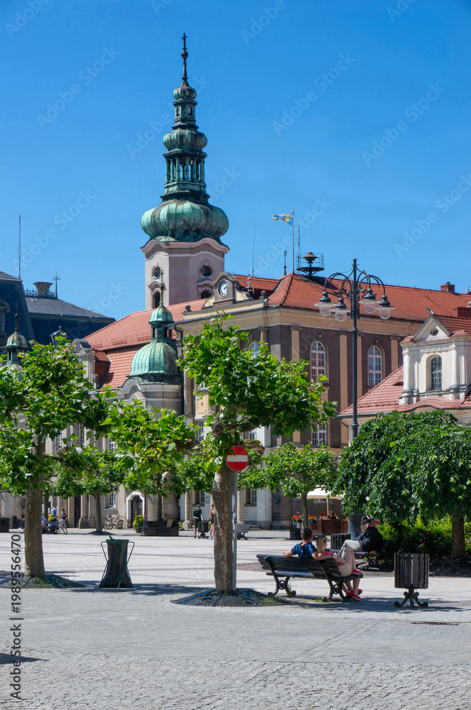 Obraz premium Summer day, Market Square (Rynek). In background rises the tower of Evangelical Church of Augsburg Confession (kościół Ewangelicko-Augsburski). Pszczyna, Poland. 