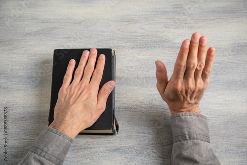 Картината върху платно Man taking oath with hand on book.
