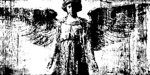 Full length angel statue standing with spread wings on backdrop