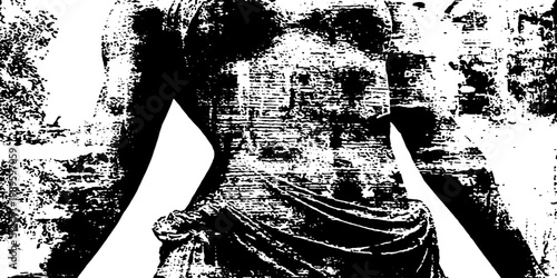 Classical statue torso draped and worn against wall