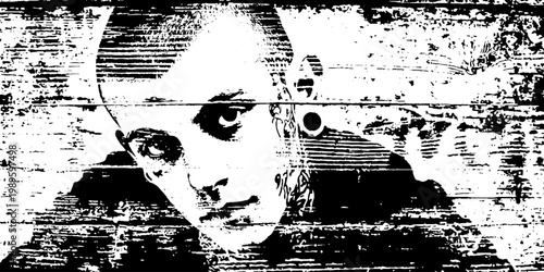 Young person staring with tattoos and piercings in grunge backdrop