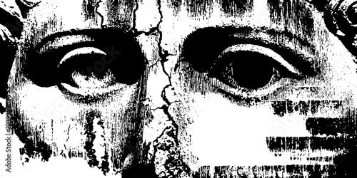 Antique carved face divided by central crack on plaster