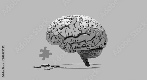 Abstract grayscale image of a human brain composed of interlocking puzzle pieces, with one element detached, symbolizing cognitive function, problem-solving, and the quest for understanding the mind