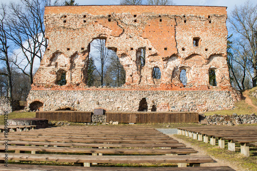 Ruins of the old fortress. Benches for summer concerts on the grounds of the old castle ruins. European touristic sightseeing of Estonia