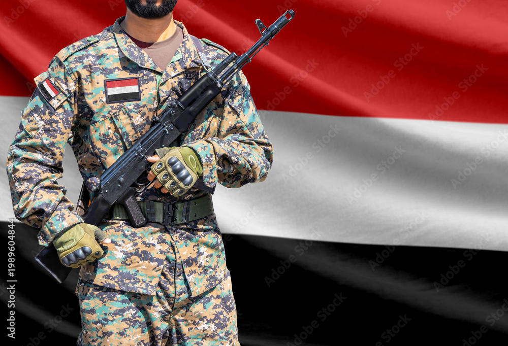 Fototapeta premium Yemen flag with soldier holding assault rifle