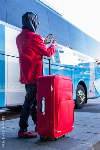 Businesswoman using navigation app while waiting for bus at airport
