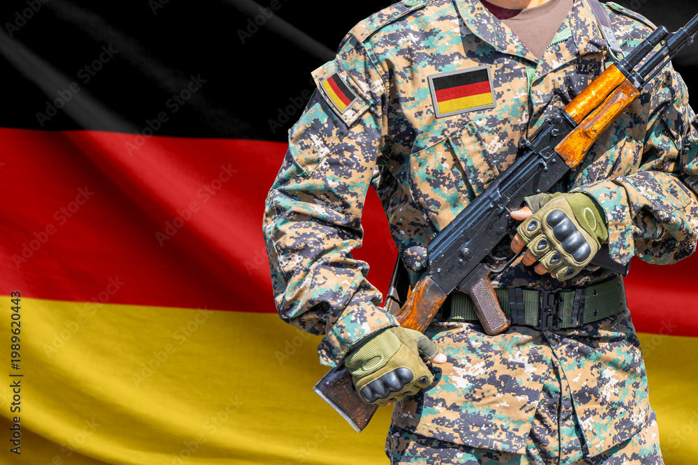 Naklejka premium Germany flag with soldier holding assault rifle