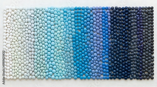 Colorful candy pieces arranged in a smooth gradient pattern from light to dark tones, creating a bright and playful visual background.	