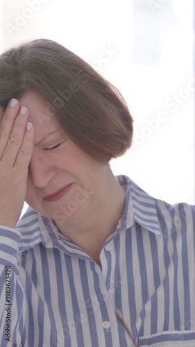 Portrait of Senior Woman having Headache, Vertical Video