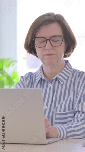 Senior Woman Thinking while Working on Laptop, Vertical Video