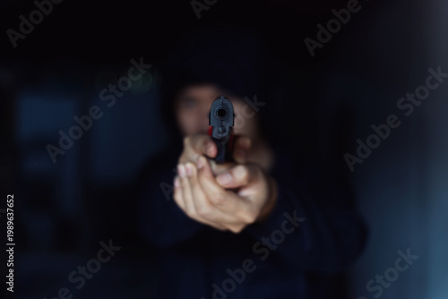 Intimidation Point of View Shot of a Hooded Person Aiming a Pistol directly