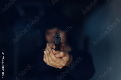 Intimidation Point of View Shot of a Hooded Person Aiming a Pistol directly