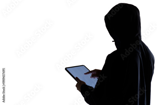 Anonymous Digital Threat: Silhouette of a Hooded Scammer Using a Tablet